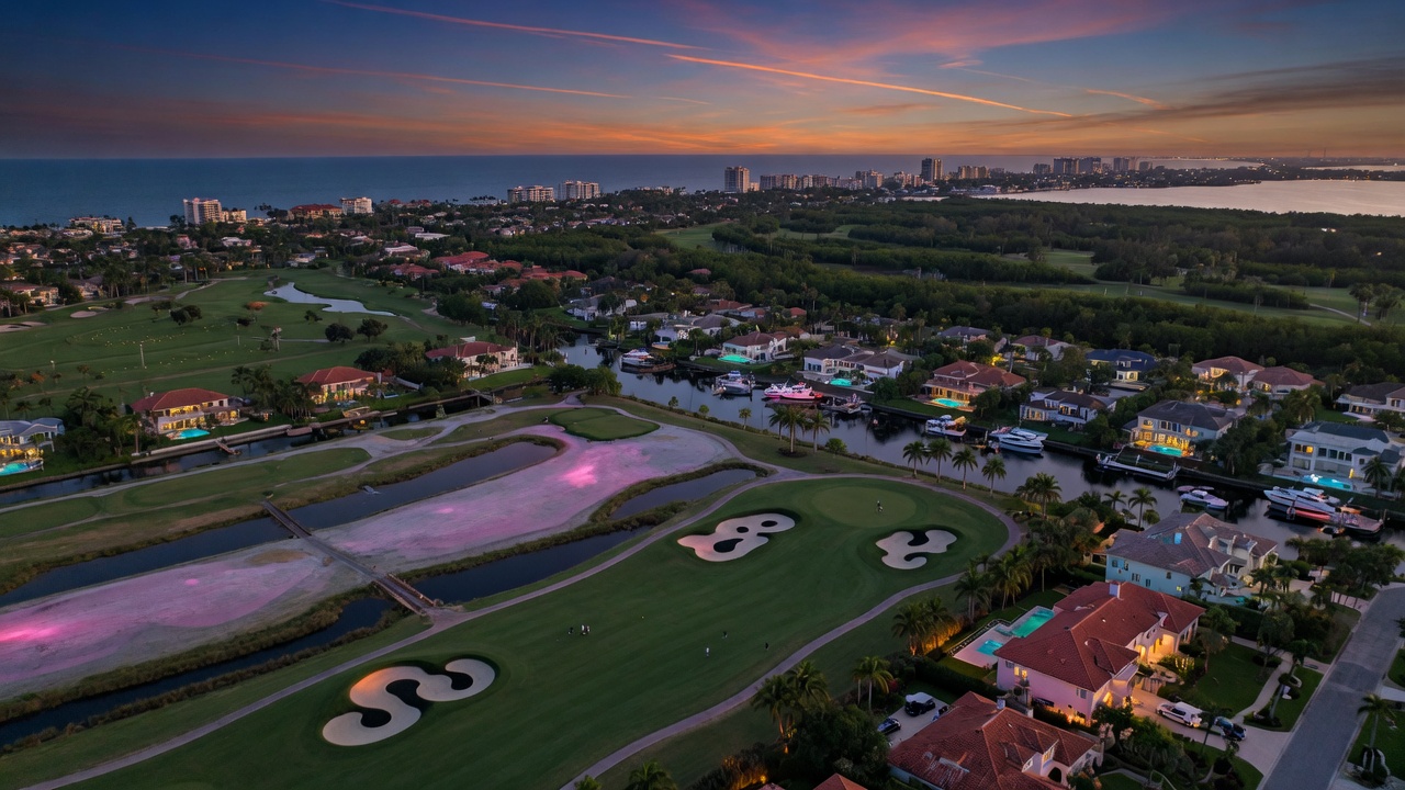 8K photorealistic aerial shot showing multiple golf courses and luxury neighborhoods in North Naples Florida at twilight